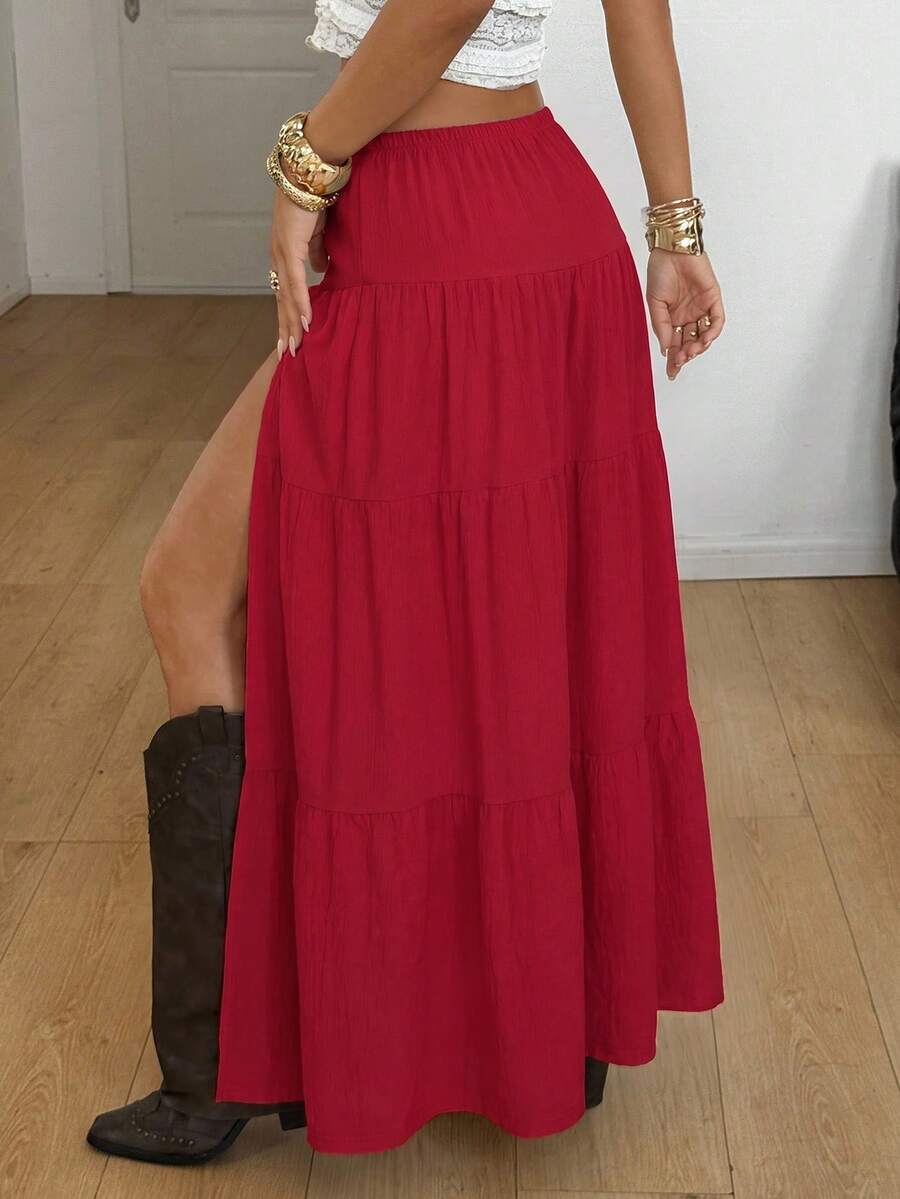 Women's black low waist split thigh long skirt featuring semi-sheer textured fabric and a flared skinny fit.
