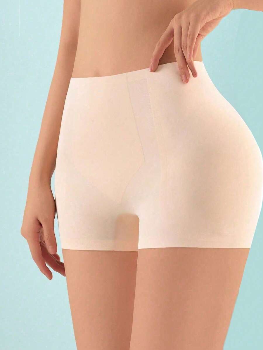 Women's high waist seamless tummy control panties with hip enhancer padding in apricot.