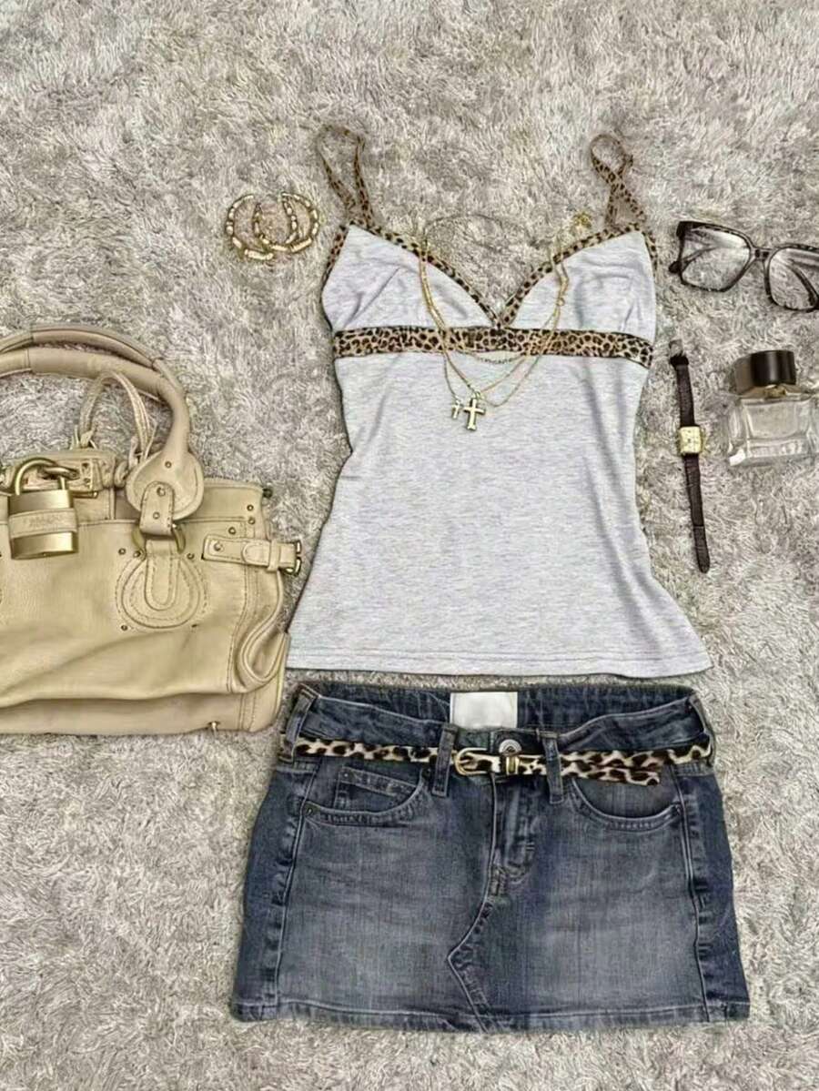A women's solid slim fit camisole top with delicate contrast lace trim around the neckline and spaghetti straps.