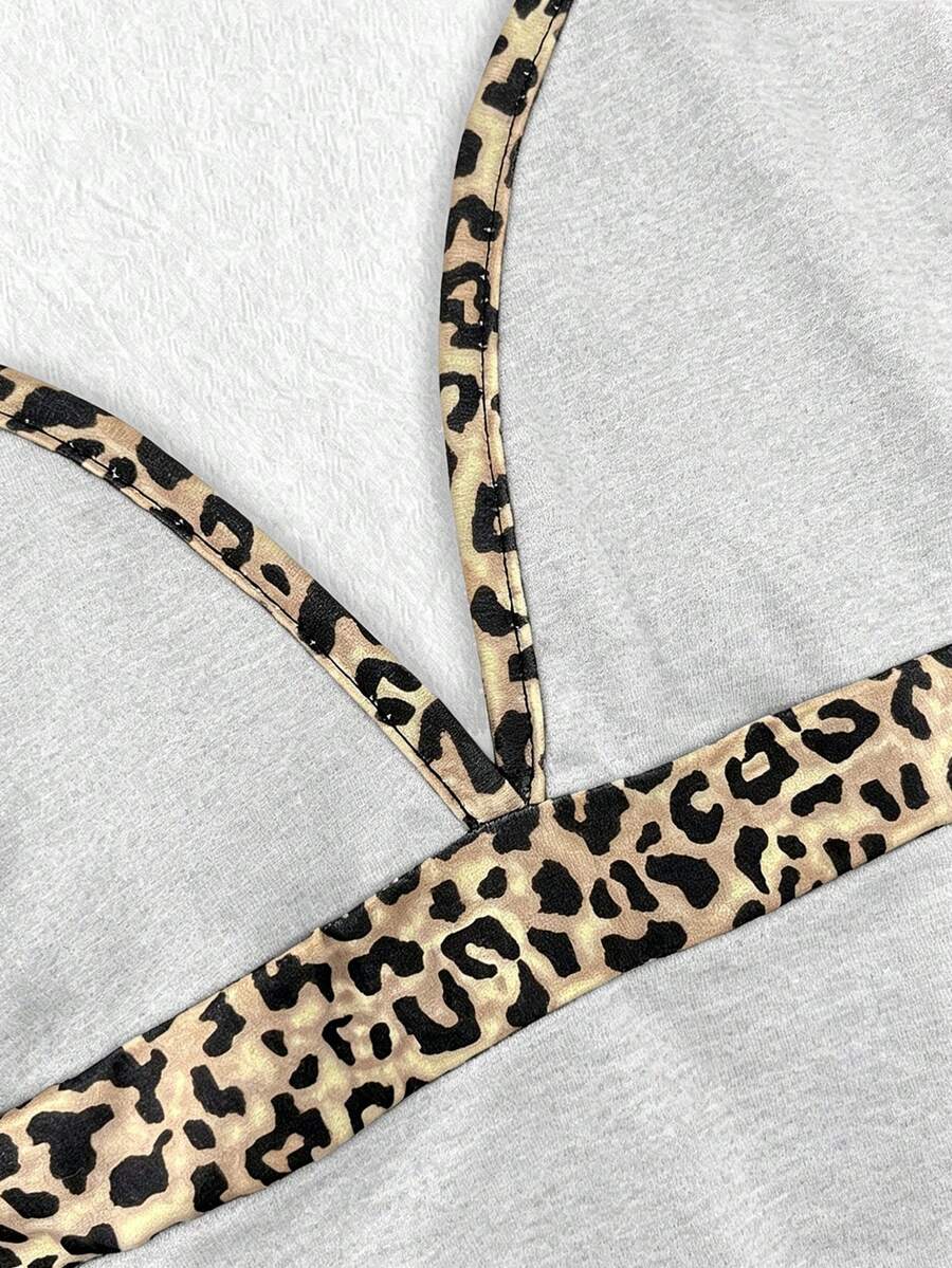 A women's solid slim fit camisole top with delicate contrast lace trim around the neckline and spaghetti straps.