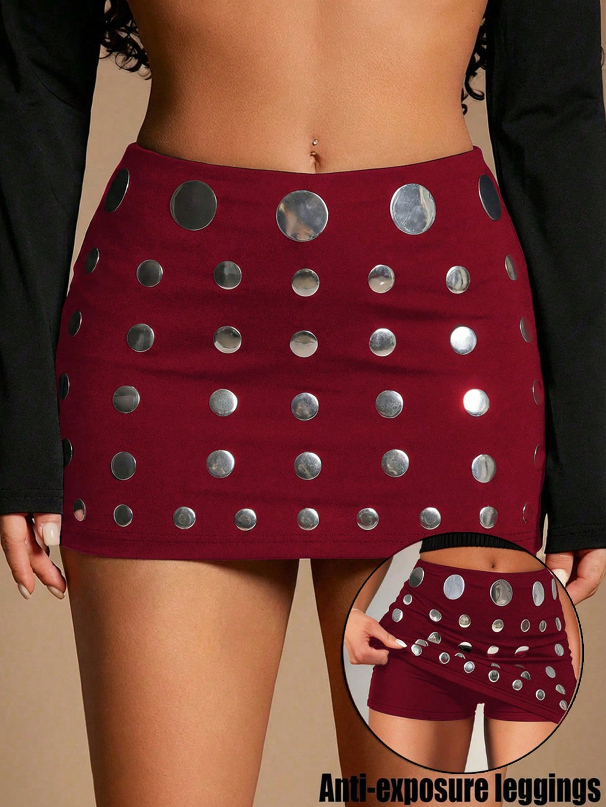 Women's black bodycon mini skort featuring a low waist, pleated side split hem, zipper closure, and built-in shorts.