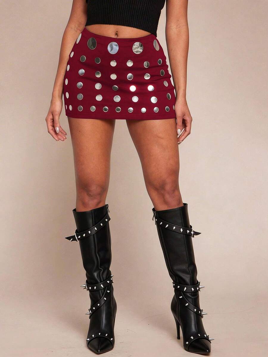 Women's black bodycon mini skort featuring a low waist, pleated side split hem, zipper closure, and built-in shorts.