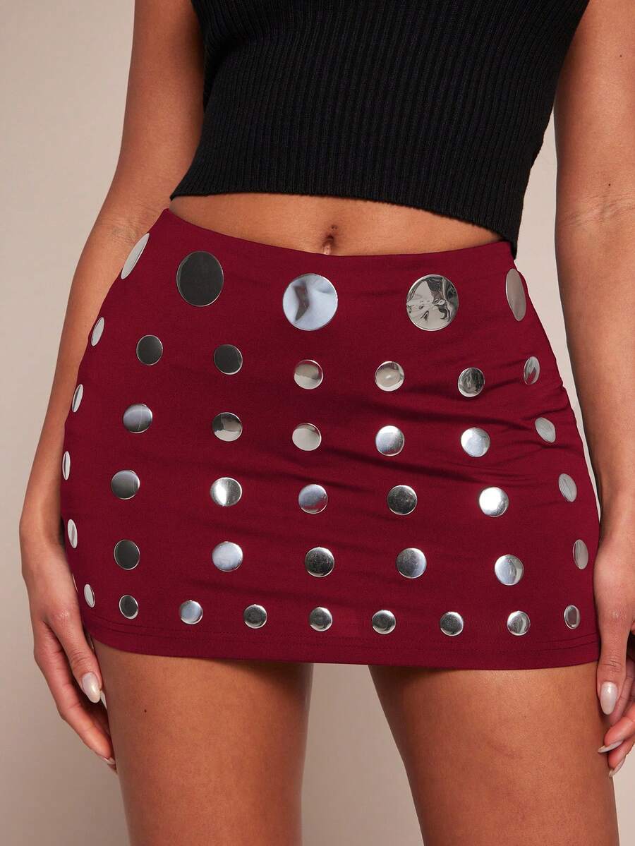 Women's black bodycon mini skort featuring a low waist, pleated side split hem, zipper closure, and built-in shorts.
