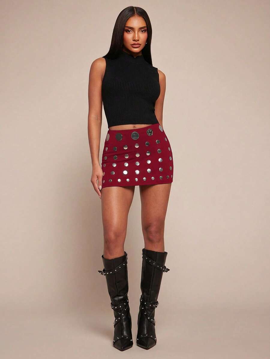 Women's black bodycon mini skort featuring a low waist, pleated side split hem, zipper closure, and built-in shorts.