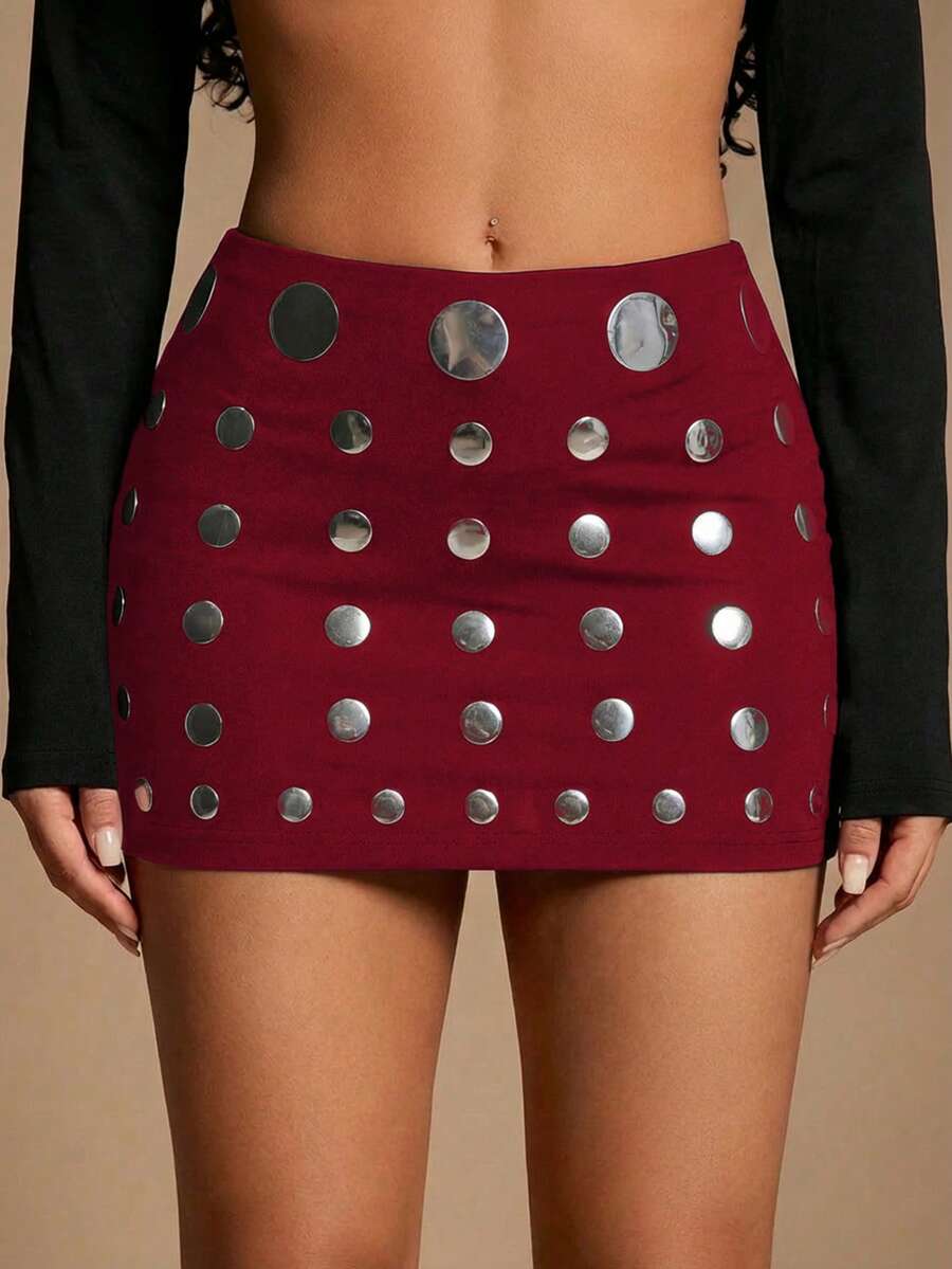 Women's black bodycon mini skort featuring a low waist, pleated side split hem, zipper closure, and built-in shorts.