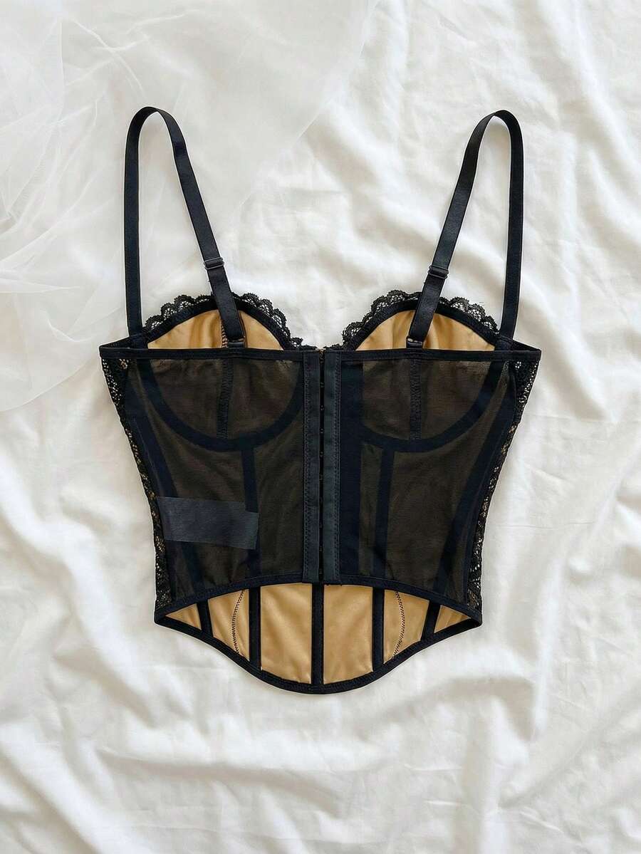 Women's lace bustier camisole top with spaghetti straps, contrast lace, lace-up detail, and an asymmetrical hem in a slim fit design.