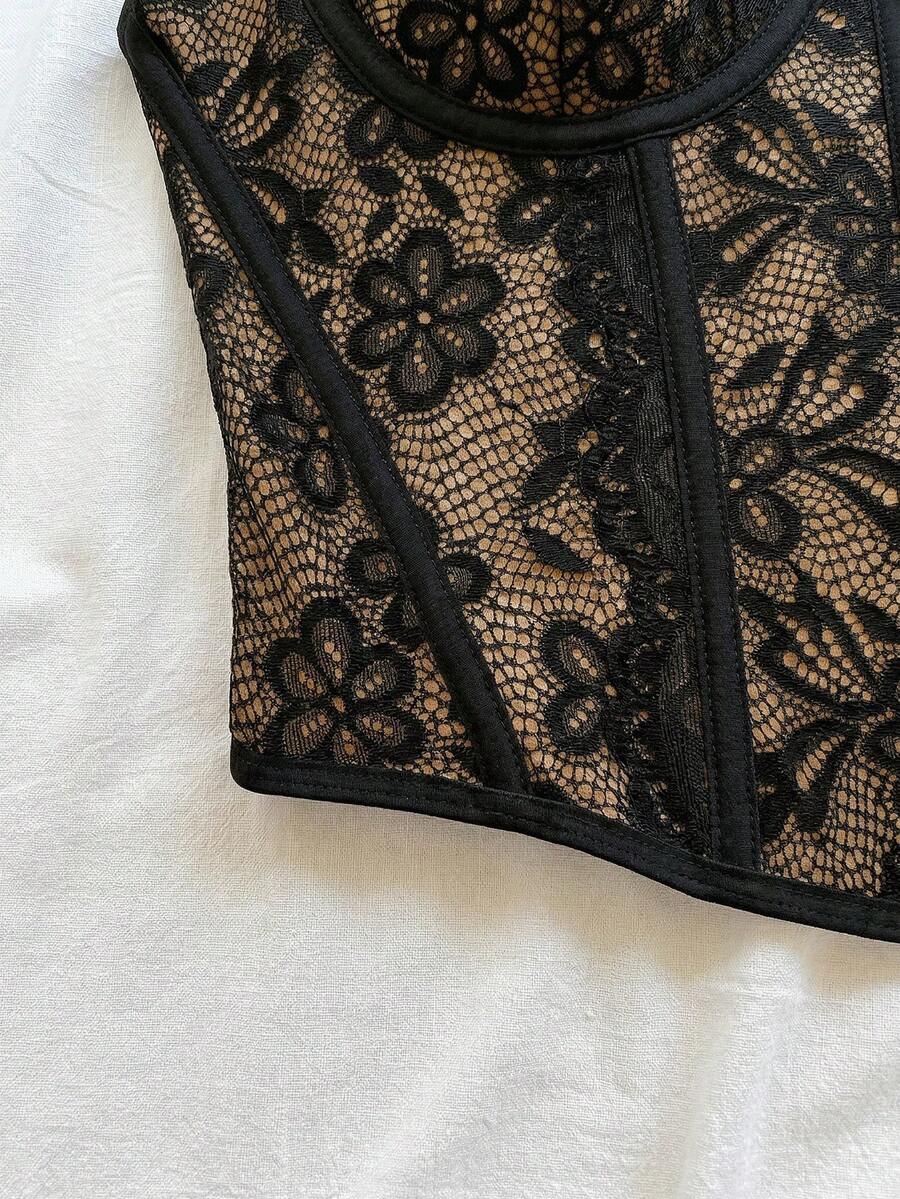 Women's lace bustier camisole top with spaghetti straps, contrast lace, lace-up detail, and an asymmetrical hem in a slim fit design.