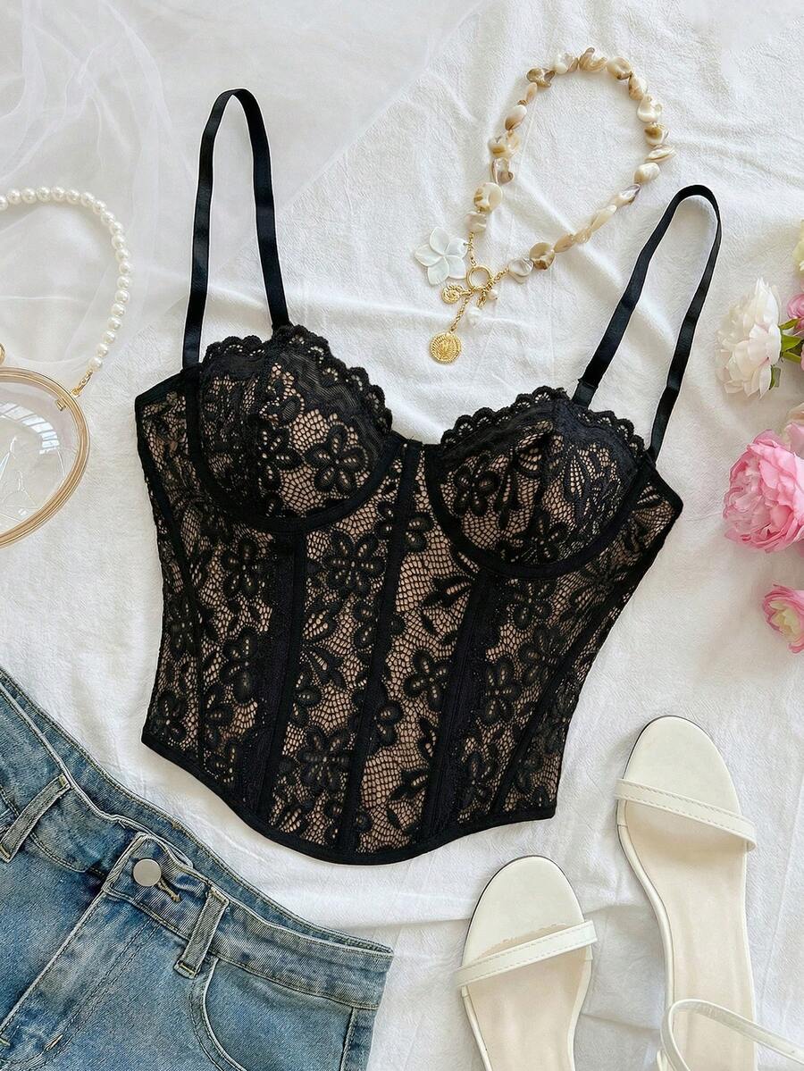 Women's lace bustier camisole top with spaghetti straps, contrast lace, lace-up detail, and an asymmetrical hem in a slim fit design.