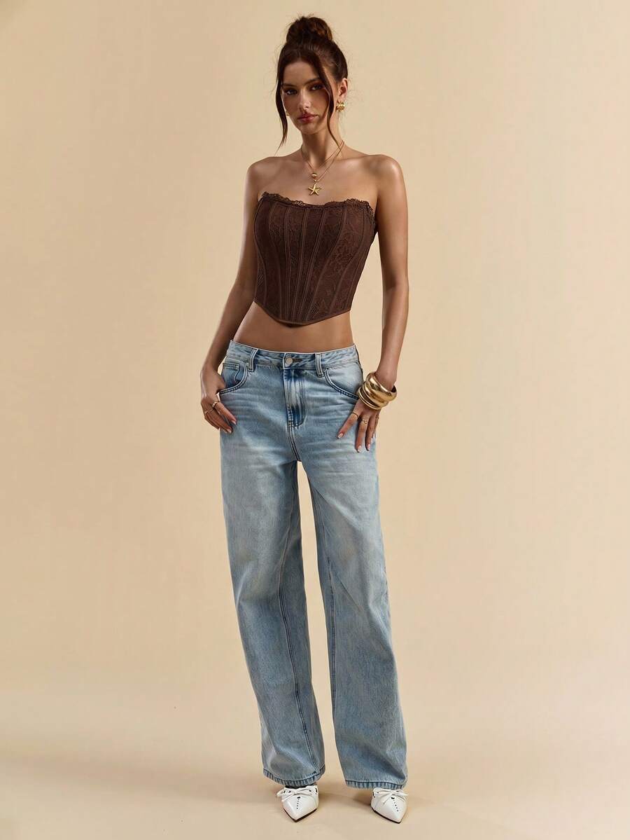 Women's strapless bustier crop top with contrast lace, lace-up detail, and an asymmetric hem in a slim-fit satin finish.