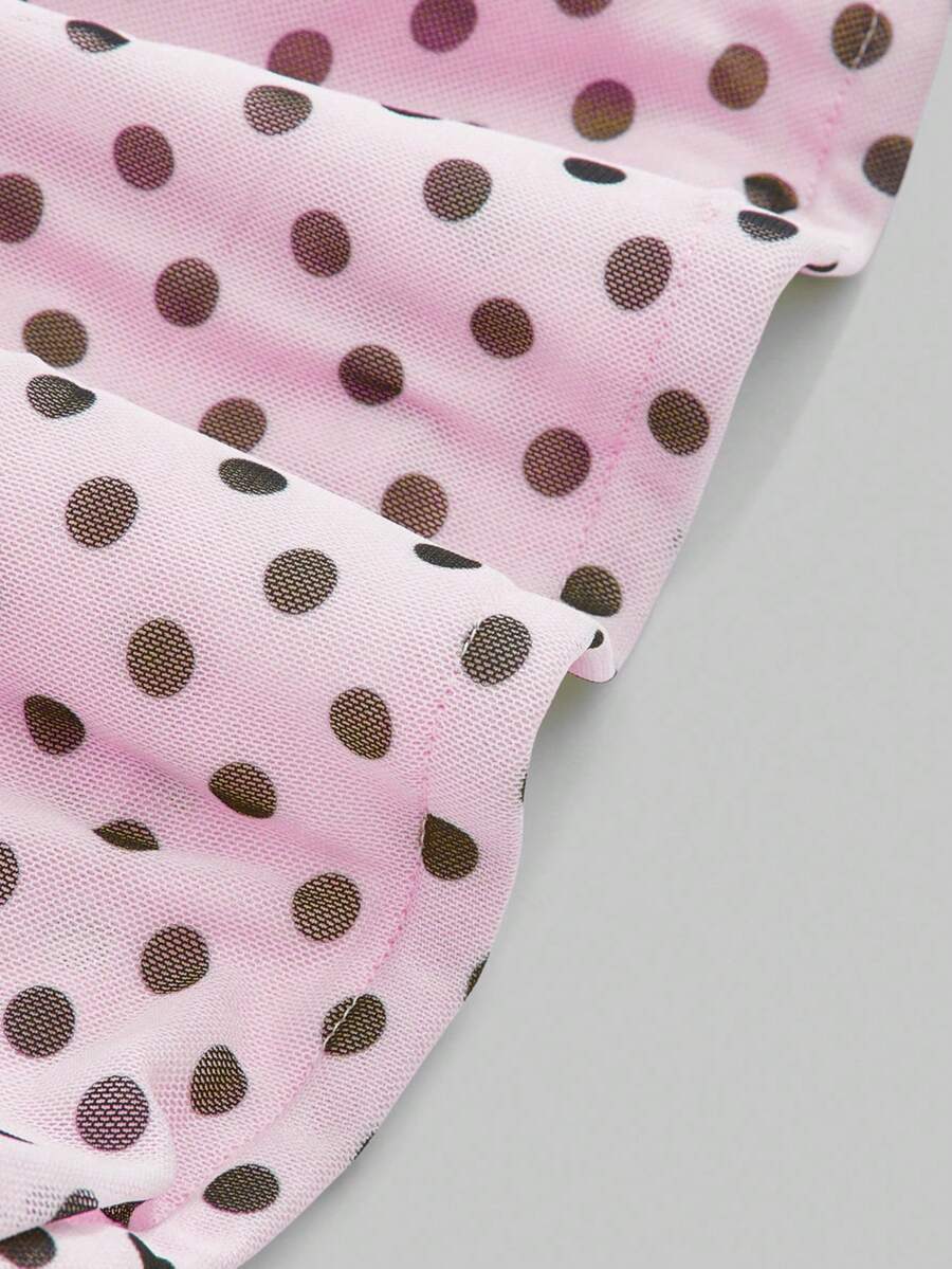 Women's black polka dot strapless tube top made of ruched mesh fabric featuring an asymmetrical hem and matching scarf.