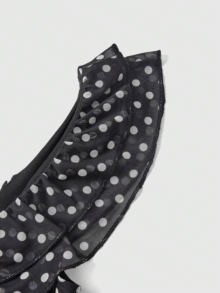 Women's black and white polka dot mesh camisole top with asymmetrical ruffle hem and square neckline.