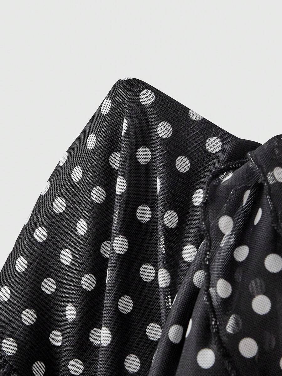 Women's black and white polka dot mesh camisole top with asymmetrical ruffle hem and square neckline.