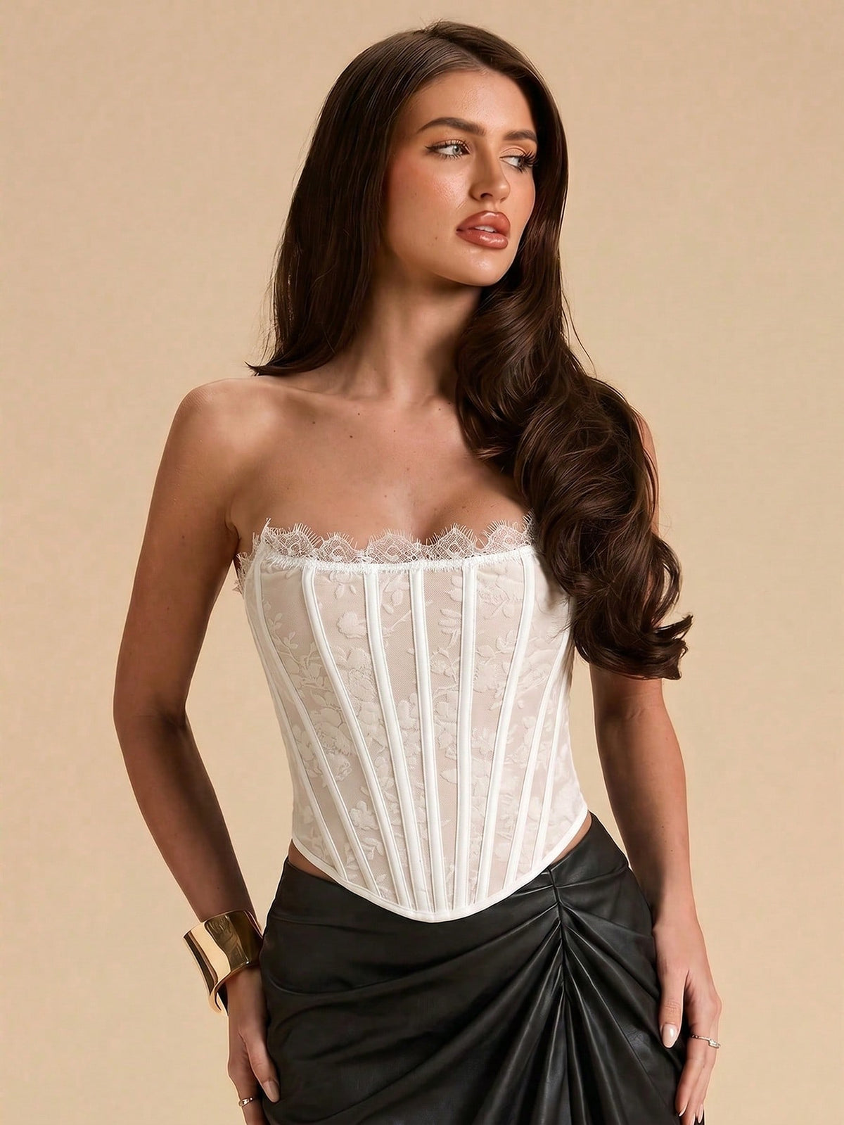 Women's strapless bustier crop top with contrast lace, lace-up detail, and an asymmetric hem in a slim-fit satin finish.