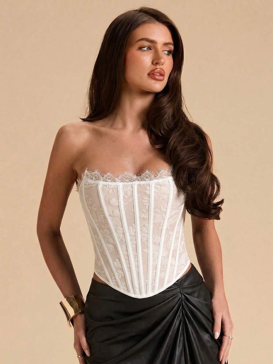 Women's strapless bustier crop top with contrast lace, lace-up detail, and an asymmetric hem in a slim-fit satin finish.
