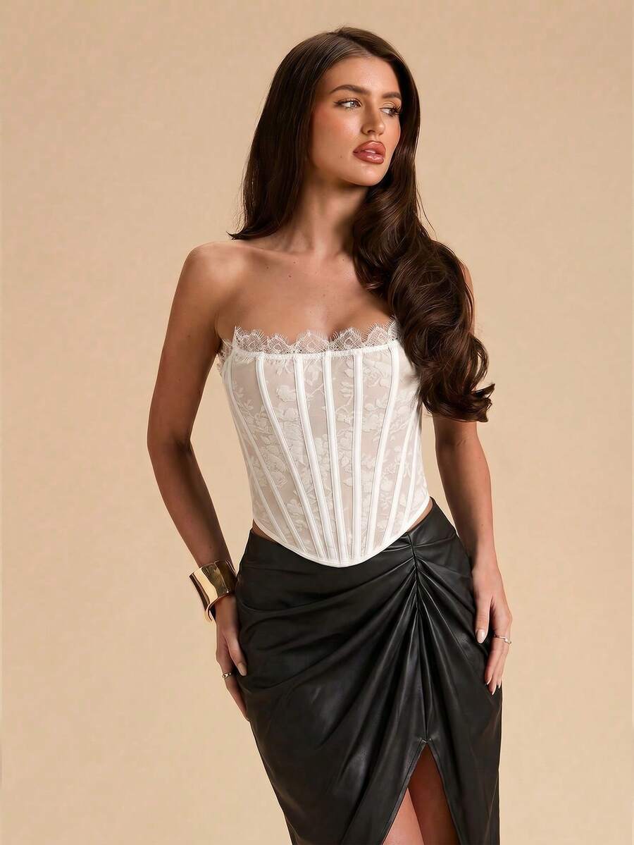 Women's strapless bustier crop top with contrast lace, lace-up detail, and an asymmetric hem in a slim-fit satin finish.
