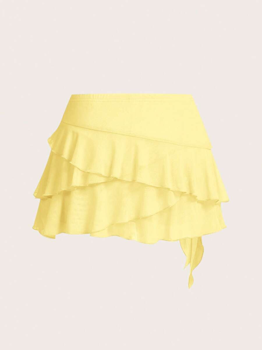 White tiered ruffle trim mini skirt for women with low waist, knot detail, mesh fabric, and casual Y2K boho design.