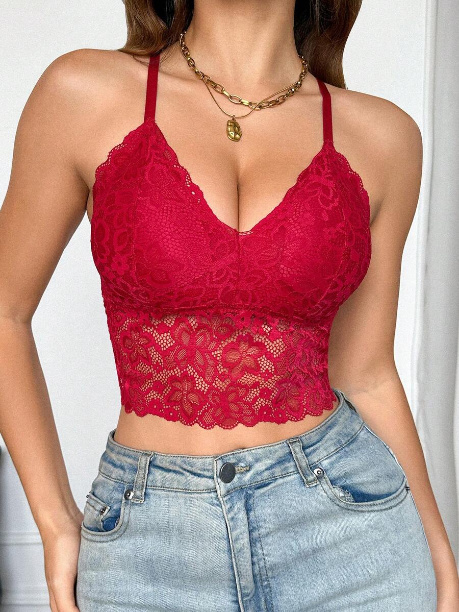Women's black lace crop cami top featuring romantic French scallop trim, criss-cross spaghetti straps, and removable padded cups.