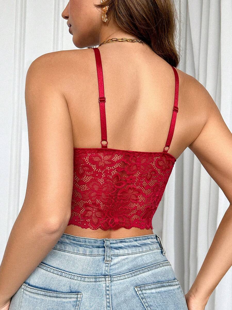 Women's black lace crop cami top featuring romantic French scallop trim, criss-cross spaghetti straps, and removable padded cups.