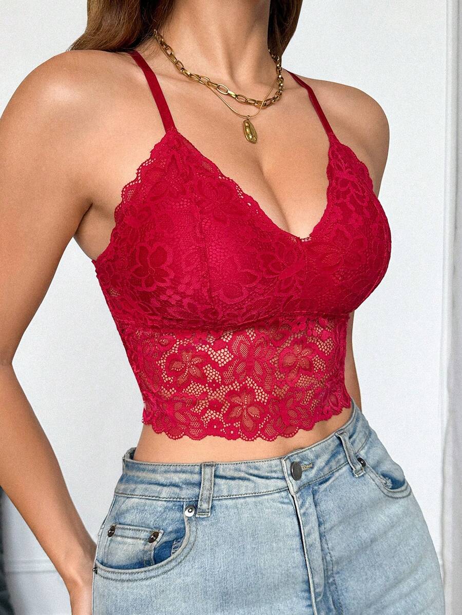 Women's black lace crop cami top featuring romantic French scallop trim, criss-cross spaghetti straps, and removable padded cups.