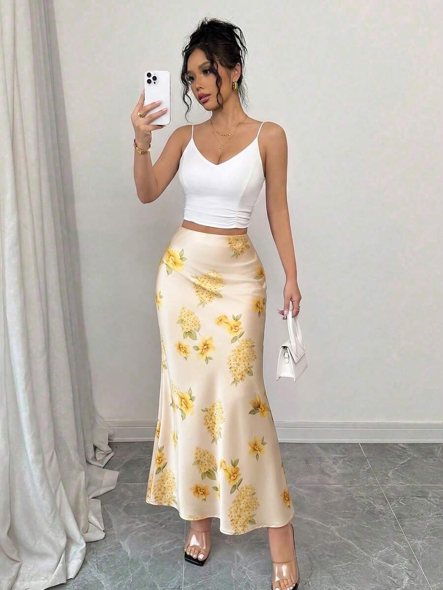 Women's elegant black A-line long skirt featuring a plain woven fabric, regular fit, natural mid-waist style, and flared hem design suitable for formal and evening wear.