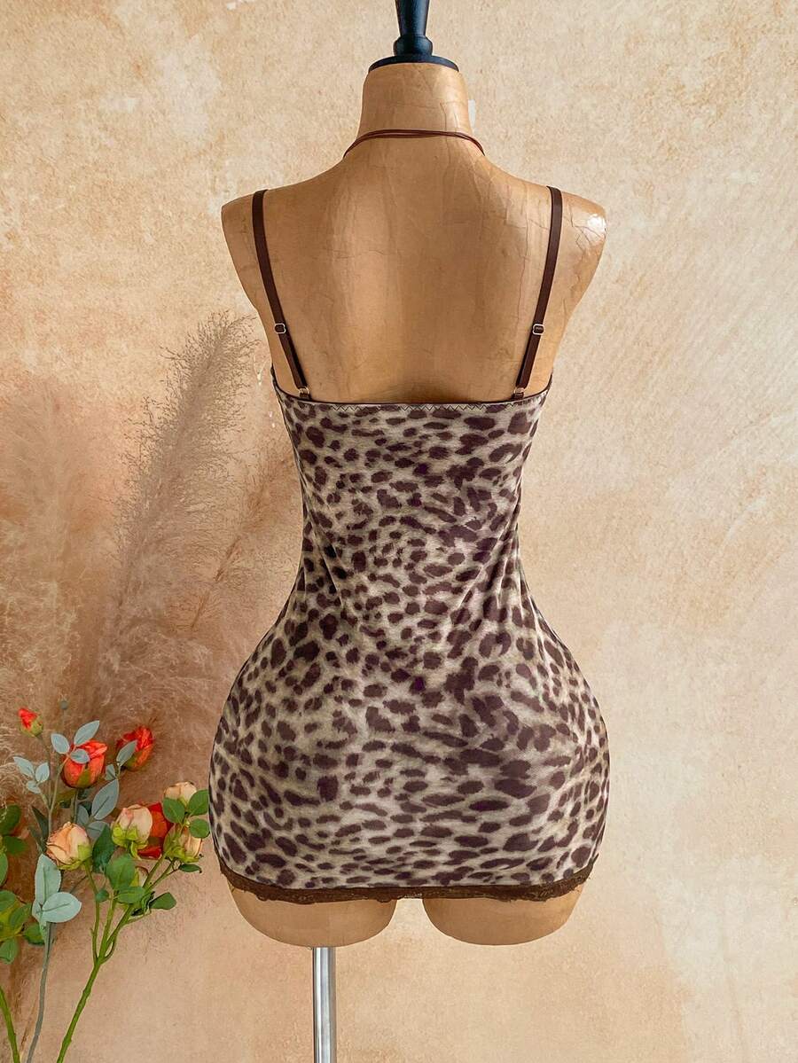 Women's black mesh bodycon mini dress featuring spaghetti straps, contrast lace cup details, backless styling, and a slim fit.
