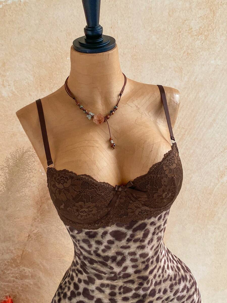 Women's black mesh bodycon mini dress featuring spaghetti straps, contrast lace cup details, backless styling, and a slim fit.