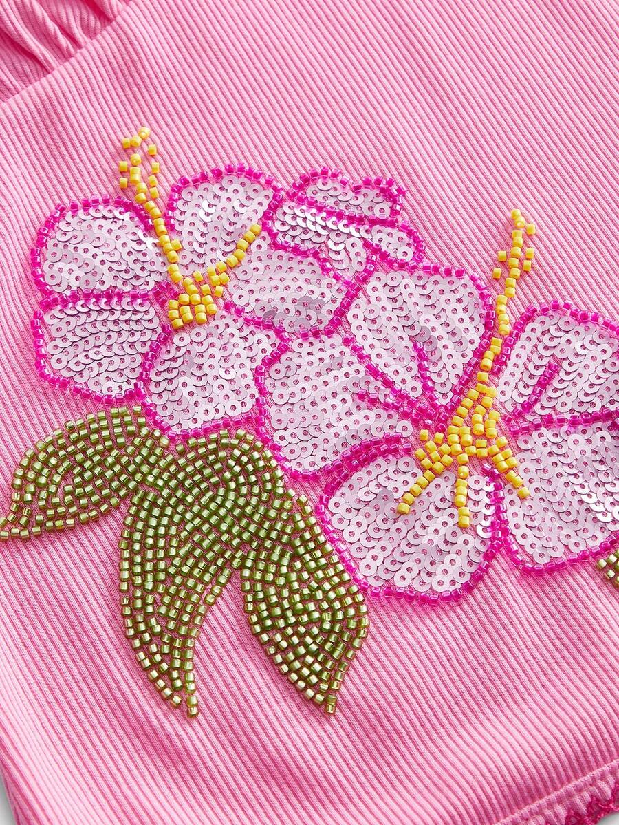 Pink women's slim fit camisole top featuring hibiscus floral embroidery, thin spaghetti straps, and high-stretch knitted fabric.
