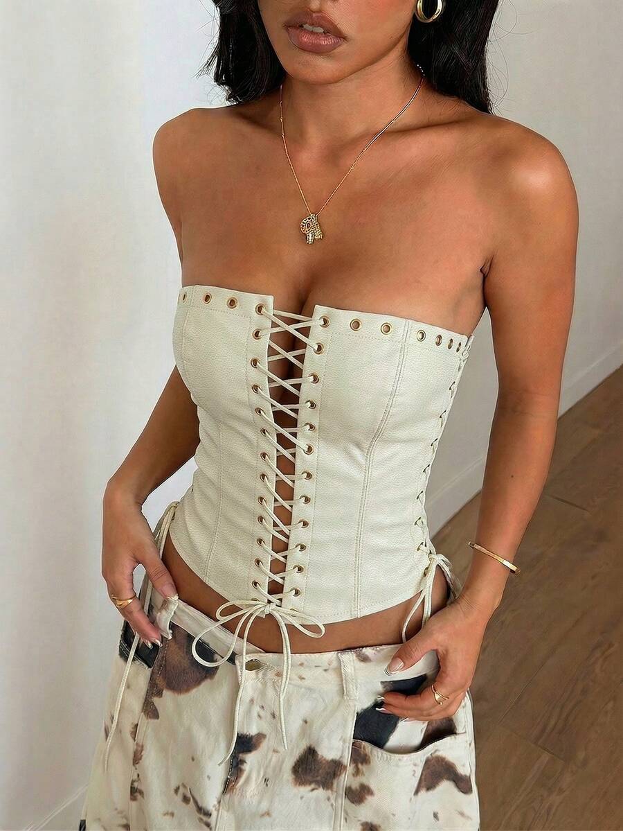 Women’s coffee brown faux leather lace-up crop top with strapless neckline, slit hem, and slim fitted silhouette for festival and nightlife wear.