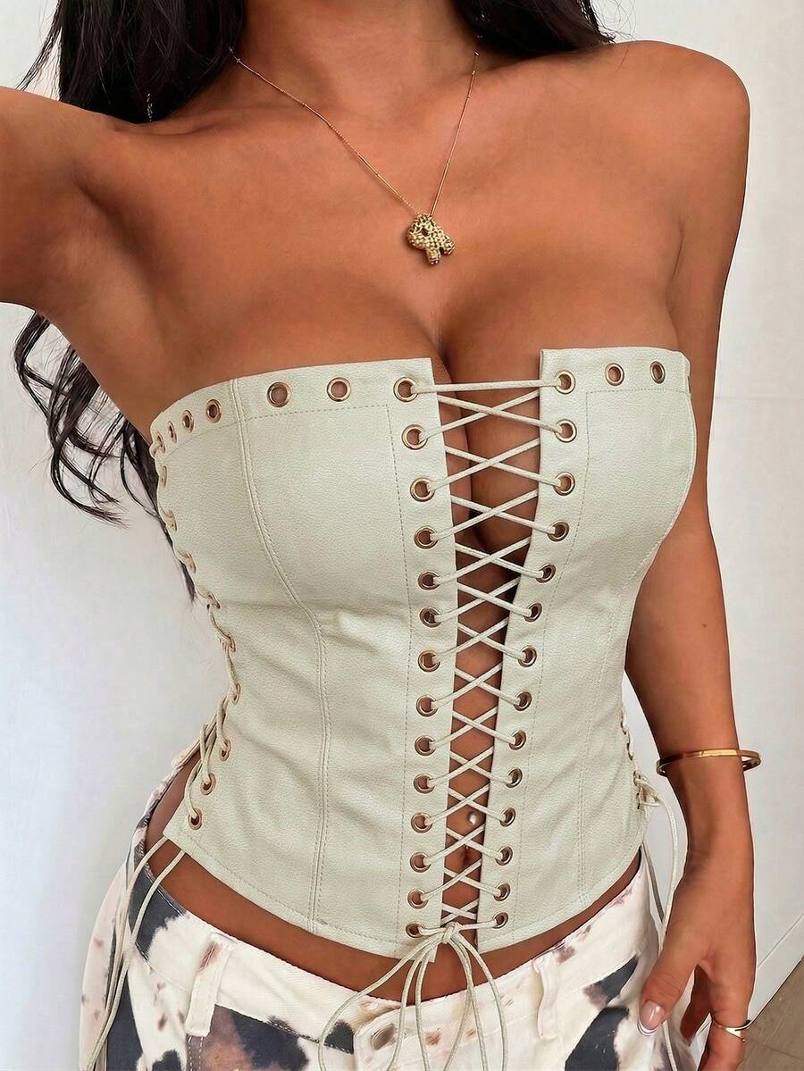 Women’s coffee brown faux leather lace-up crop top with strapless neckline, slit hem, and slim fitted silhouette for festival and nightlife wear.
