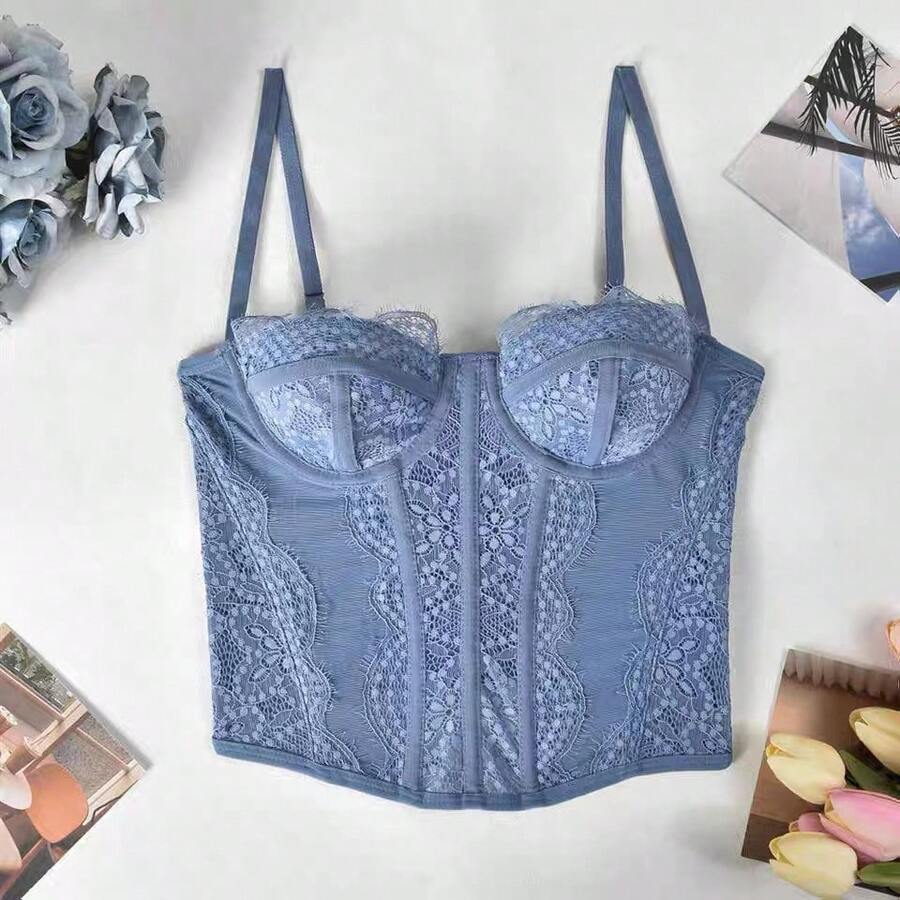 Black lace bustier corset top for women with buckle detail, spaghetti straps, slim fit, and lightweight mesh fabric for a night out look.