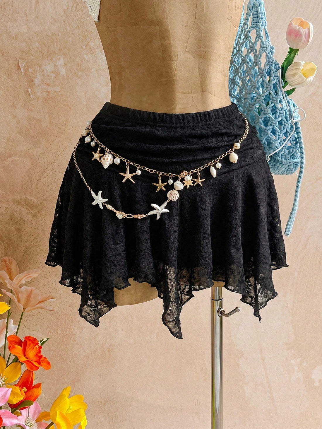 Black low waist asymmetric hem lace mini skirt for women featuring lace-up tie back details and skinny fit.