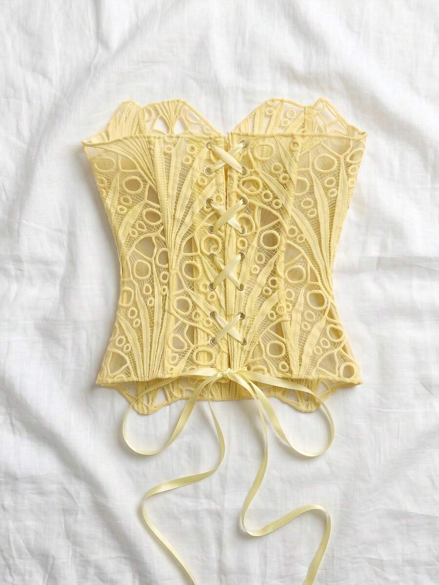 Women’s strapless corset bustier top with lace-up detail, asymmetrical embroidery, semi-sheer finish, and slim fit.
