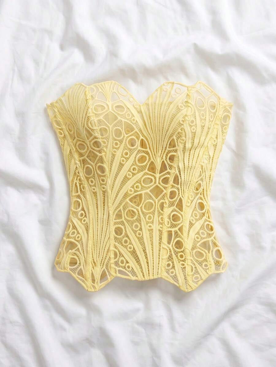 Women’s strapless corset bustier top with lace-up detail, asymmetrical embroidery, semi-sheer finish, and slim fit.