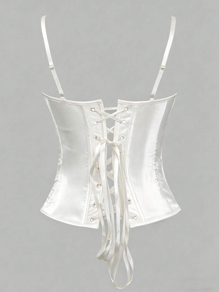 Black satin corset top for women with 3D floral rose details, boned slim-fit bodice, thin spaghetti straps, lace-up open back, and asymmetrical curved hem.