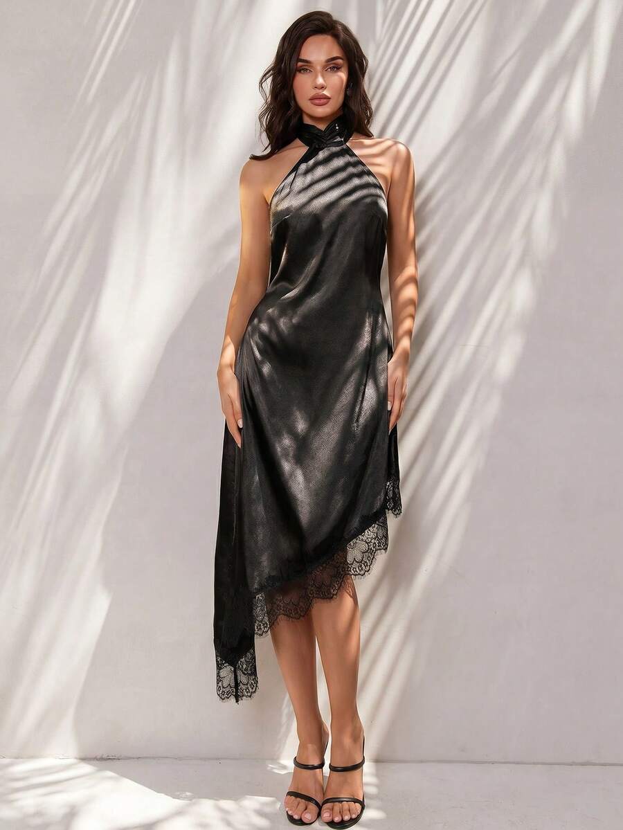 Black halter neck mini dress for women featuring a backless design with a large bow detail and an asymmetric contrast lace hem.