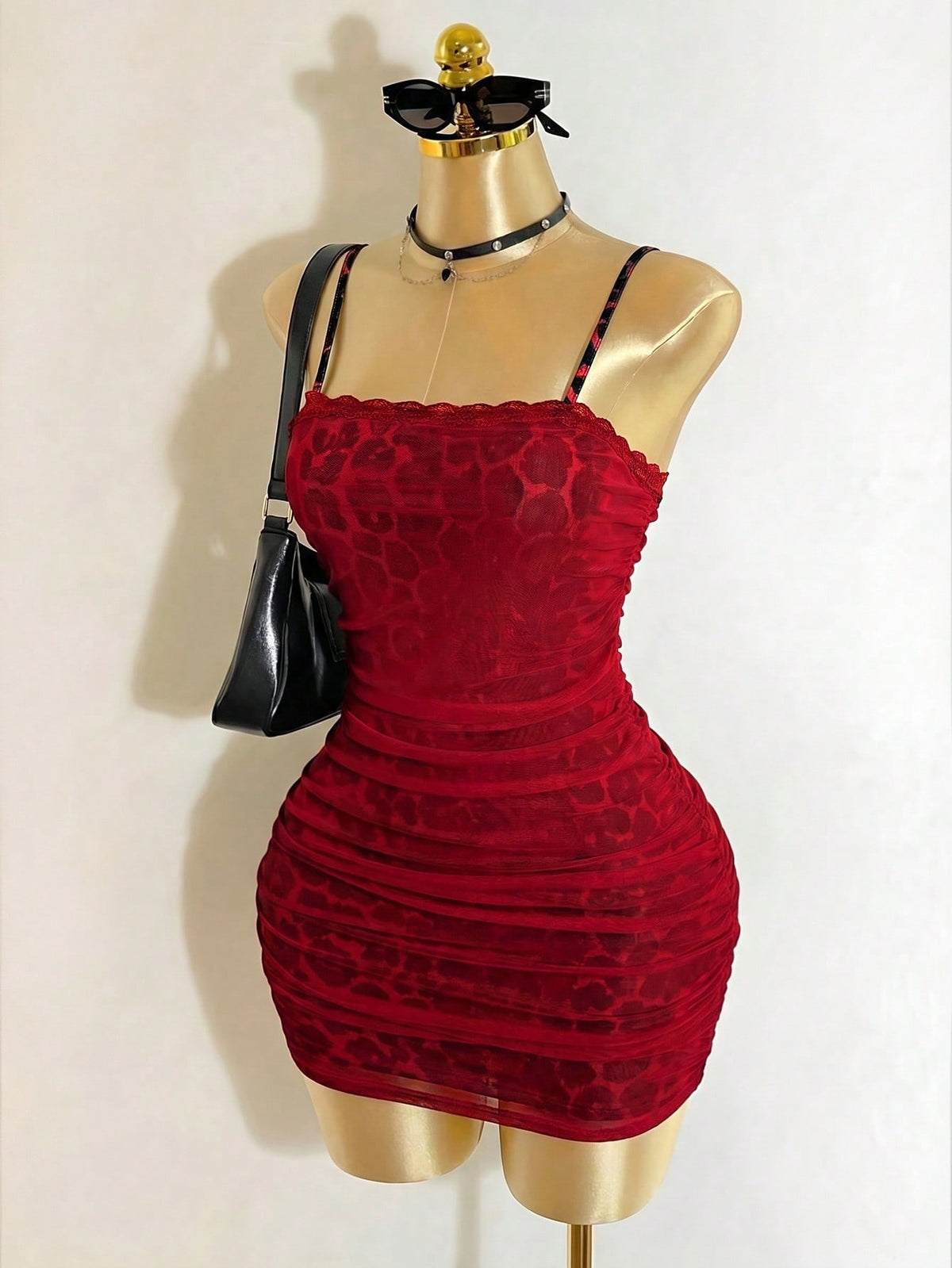 Black sleeveless mesh cami mini dress featuring spaghetti straps and slim fit design for women.