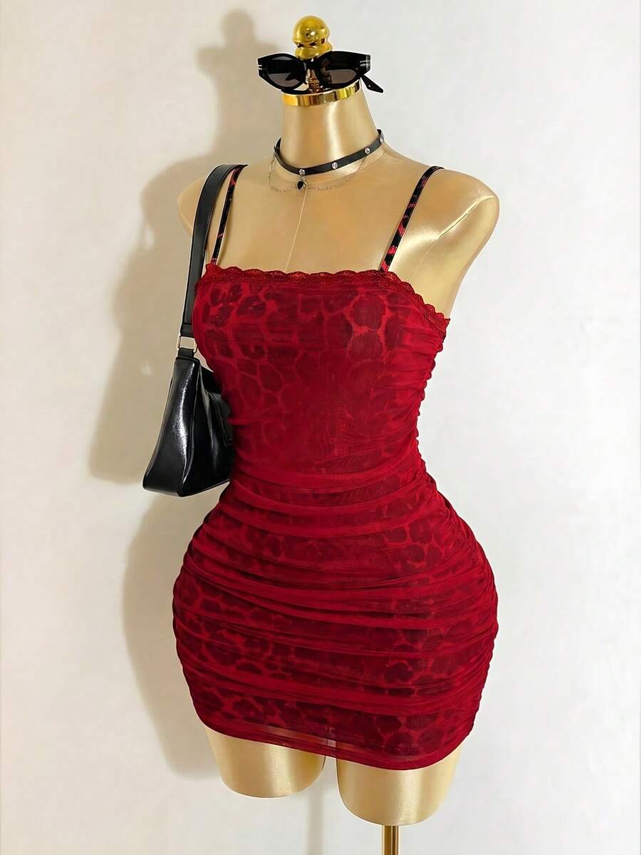 Black sleeveless mesh cami mini dress featuring spaghetti straps and slim fit design for women.