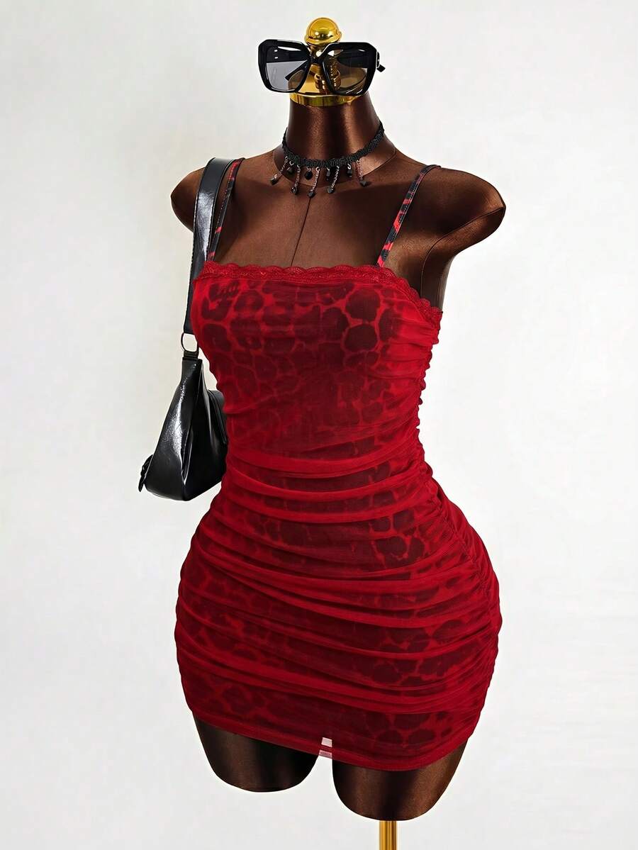 Black sleeveless mesh cami mini dress featuring spaghetti straps and slim fit design for women.