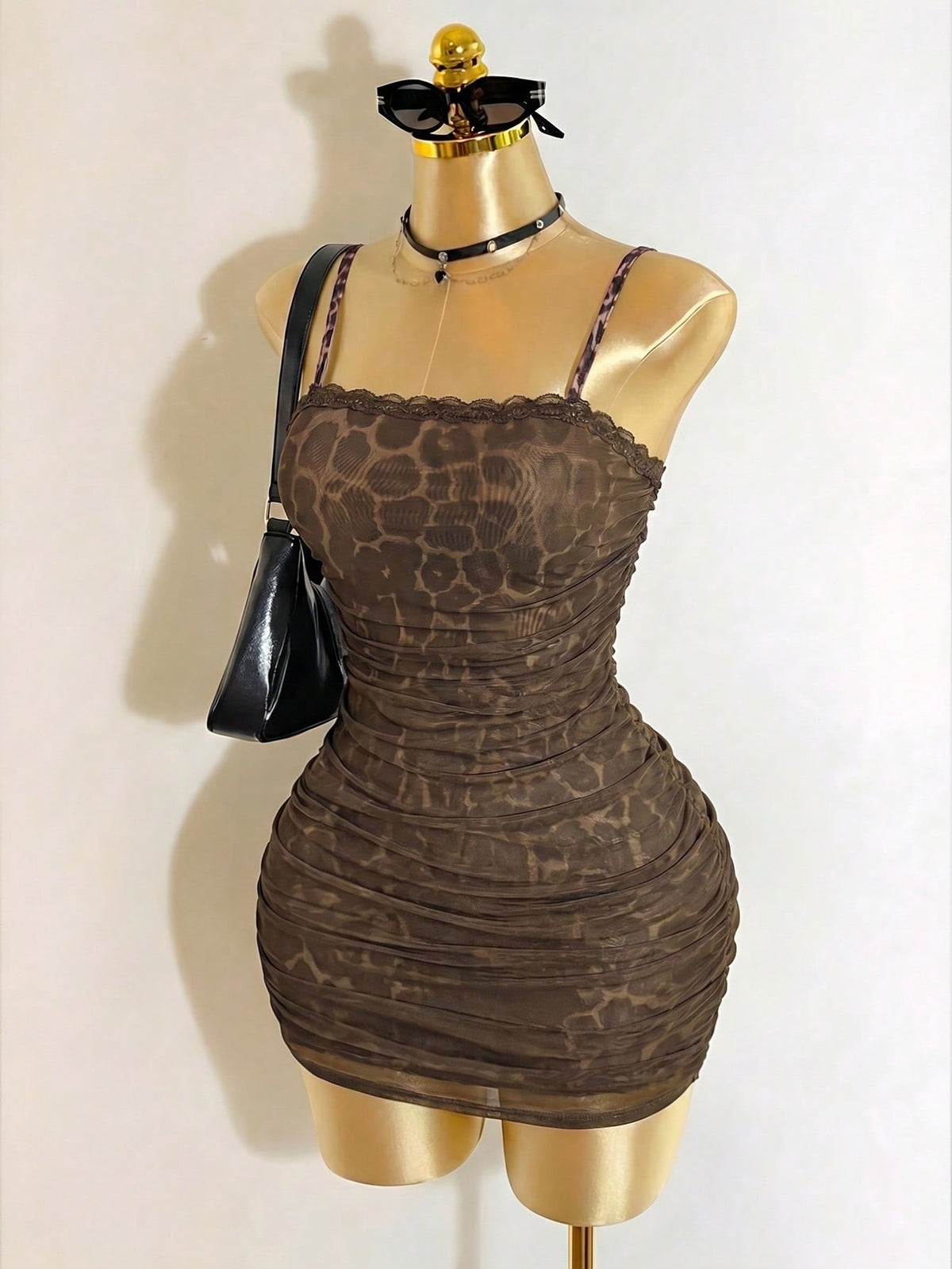 Black sleeveless mesh cami mini dress featuring spaghetti straps and slim fit design for women.