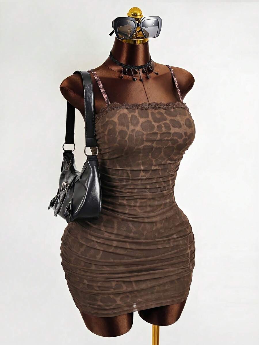 Black sleeveless mesh cami mini dress featuring spaghetti straps and slim fit design for women.