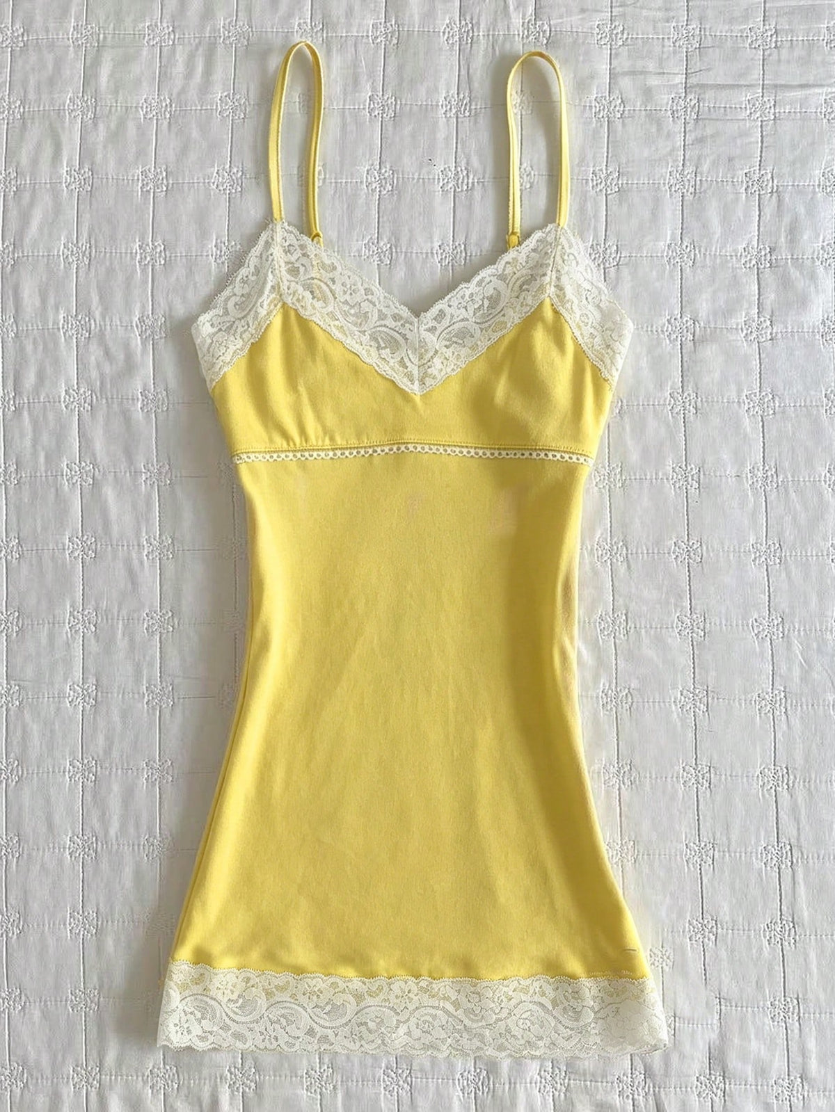 Women's solid color slim fit camisole top featuring delicate lace patchwork embroidery and tank straps.