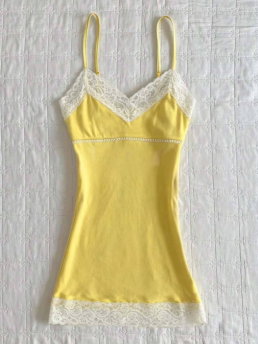 Women's solid color slim fit camisole top featuring delicate lace patchwork embroidery and tank straps.