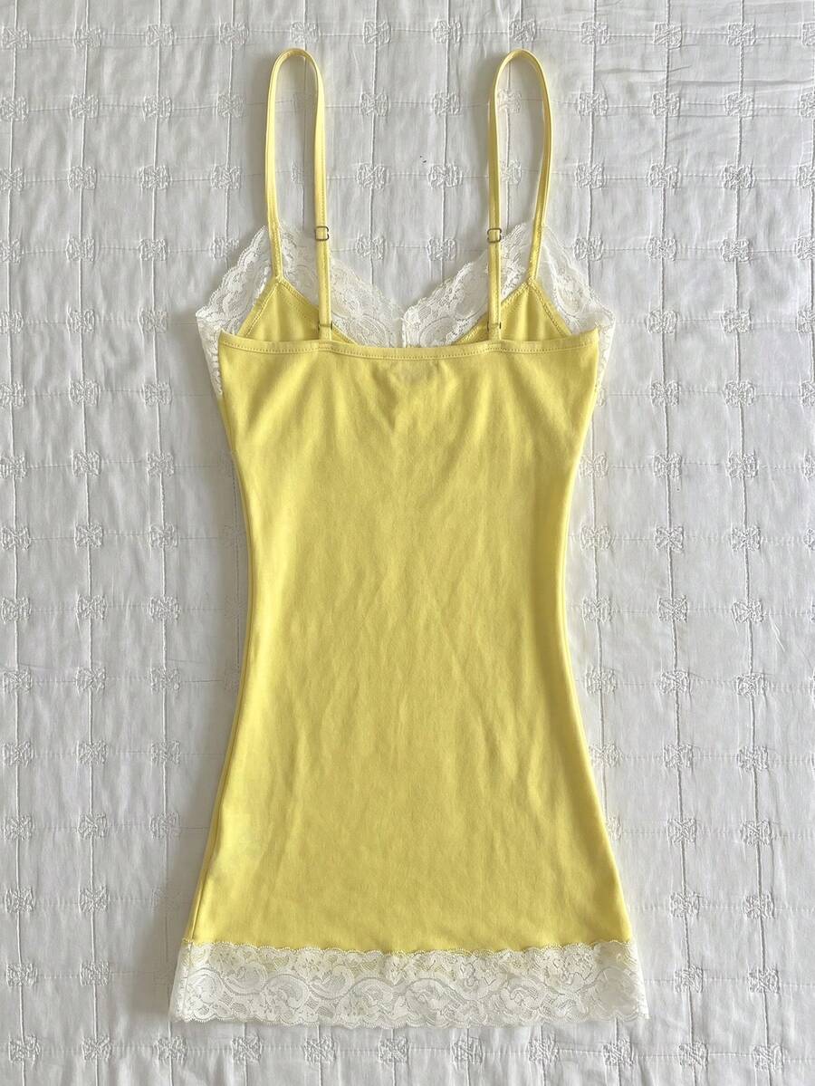 Women's solid color slim fit camisole top featuring delicate lace patchwork embroidery and tank straps.