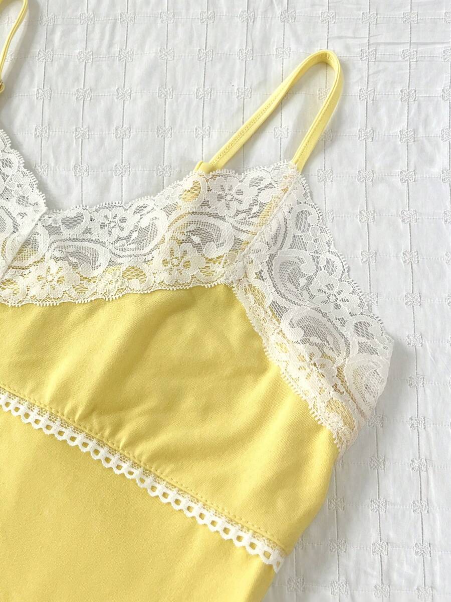 Women's solid color slim fit camisole top featuring delicate lace patchwork embroidery and tank straps.