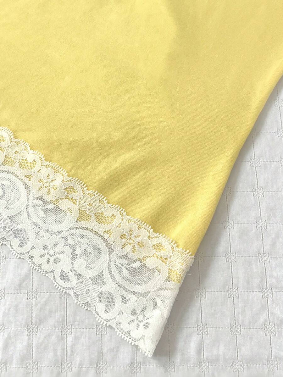 Women's solid color slim fit camisole top featuring delicate lace patchwork embroidery and tank straps.