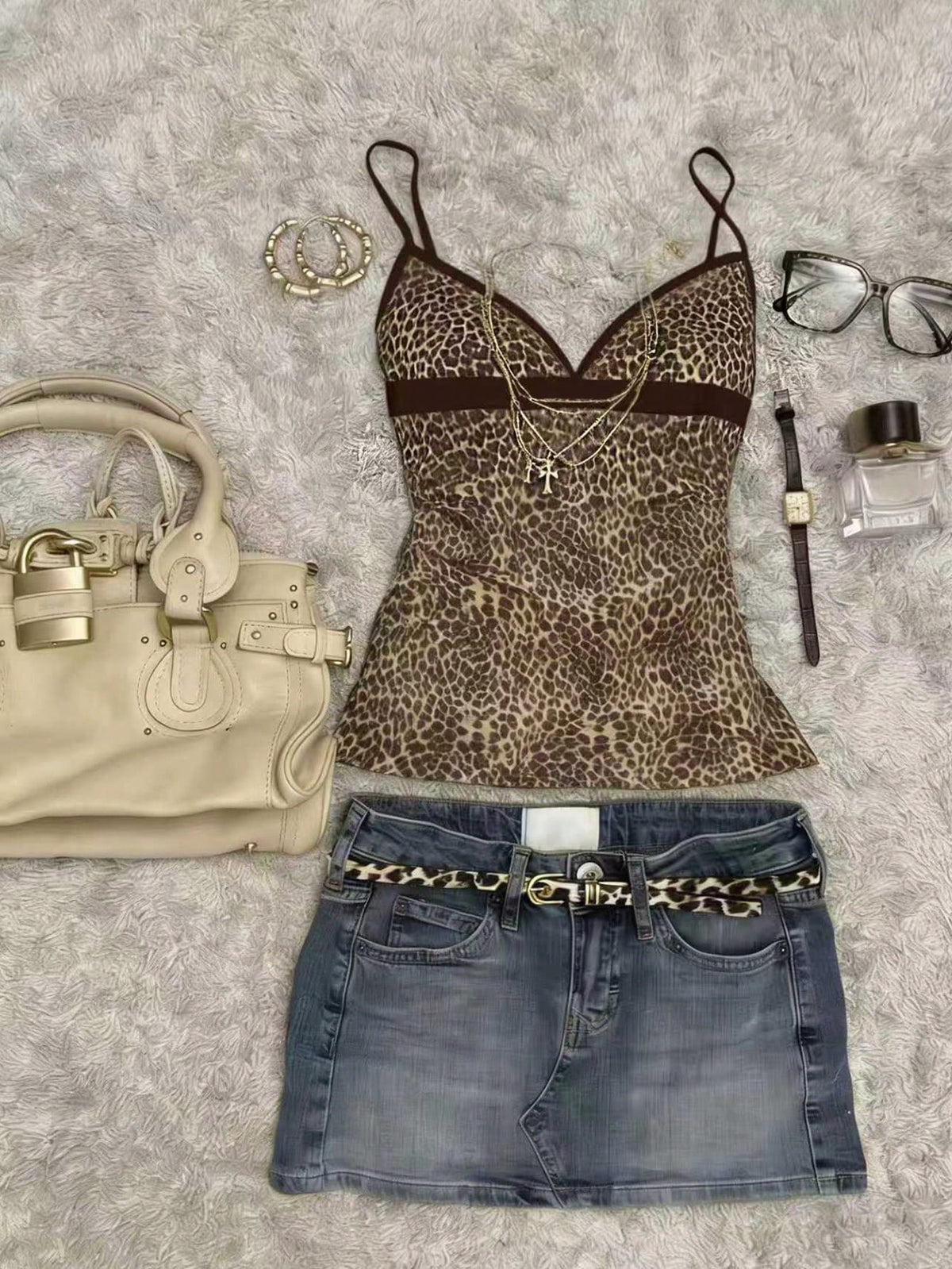 A women's solid slim fit camisole top with delicate contrast lace trim around the neckline and spaghetti straps.