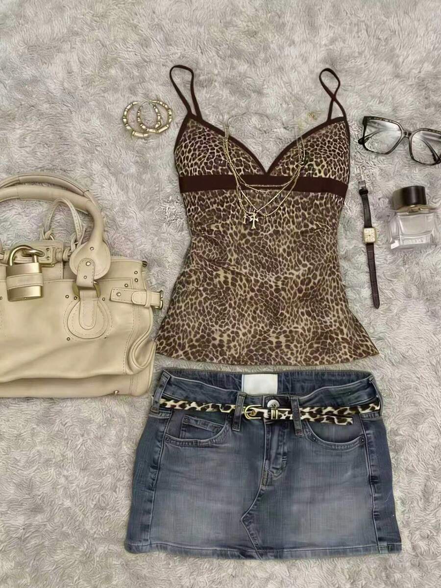 A women's solid slim fit camisole top with delicate contrast lace trim around the neckline and spaghetti straps.