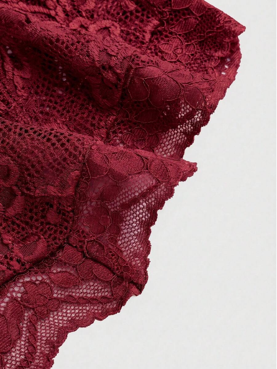 Women's black lace halter neck camisole featuring a backless crop silhouette, contrast lace trim, and scallop hem.