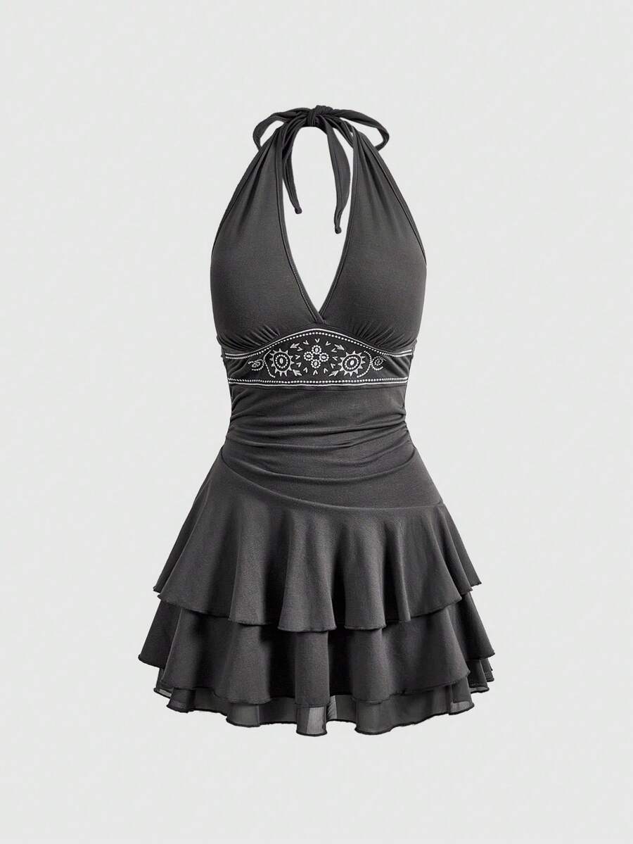 Women's sun totem embroidered sleeveless layered mini dress featuring a halter neck, backless tie back design, and slim fit high-waist A-line silhouette.