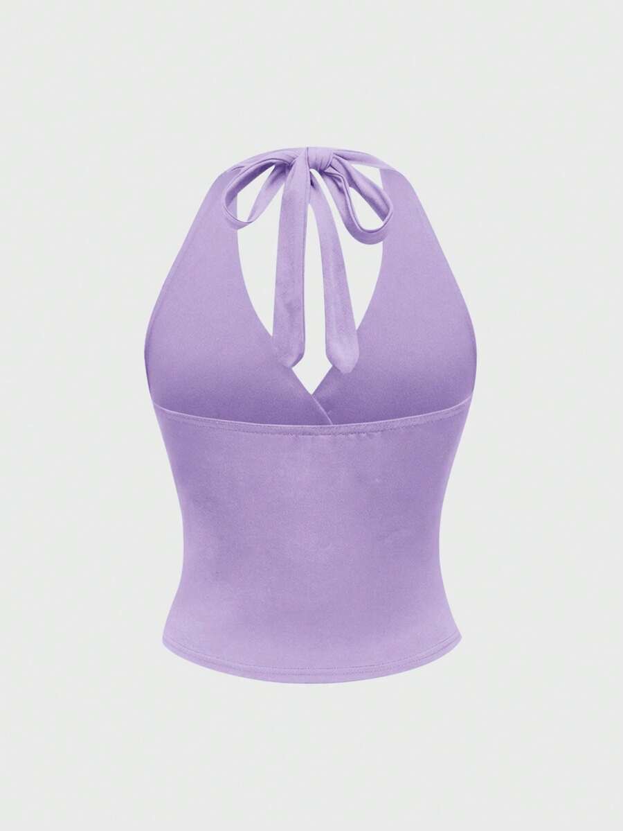 Women's halter crop tank top featuring a backless silhouette and ruched detailing in a slim fit design.